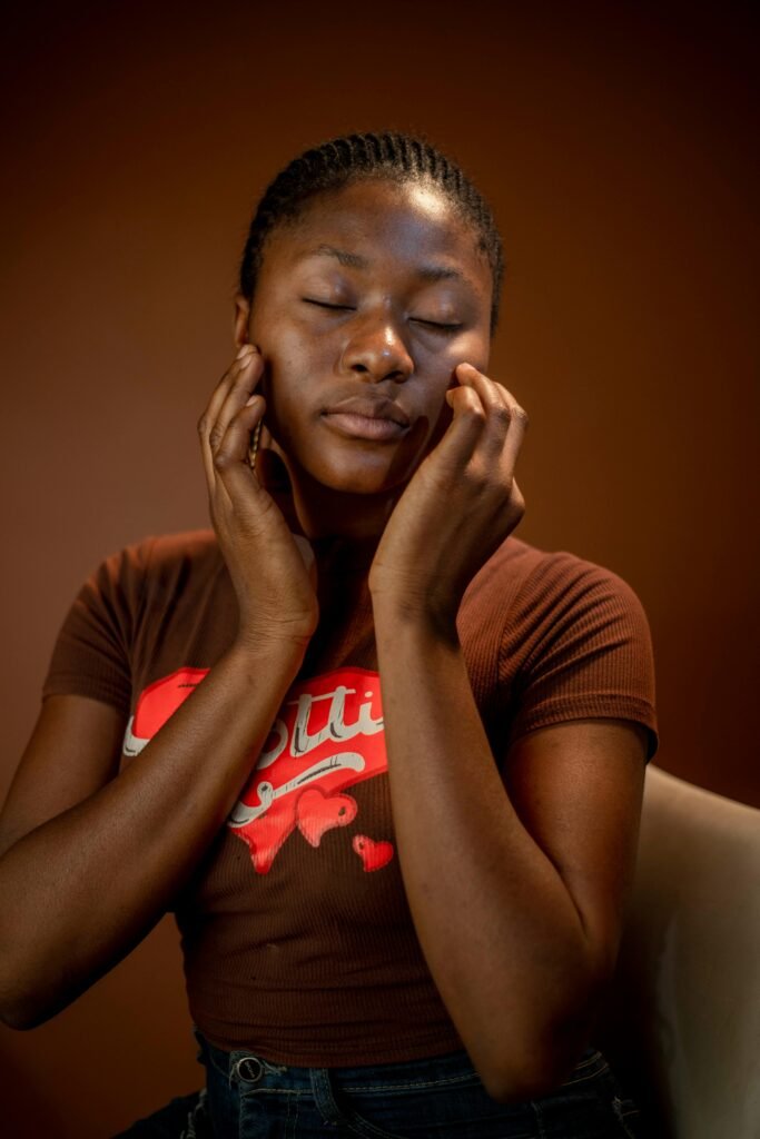 Arquivos de blogs Young woman in brown t-shirt relaxing with closed eyes against a warm background.
